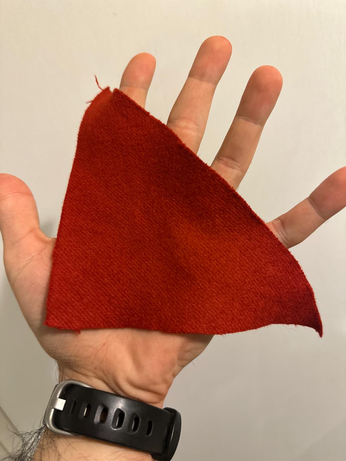 A triangle of wool fabric hand-dyed red